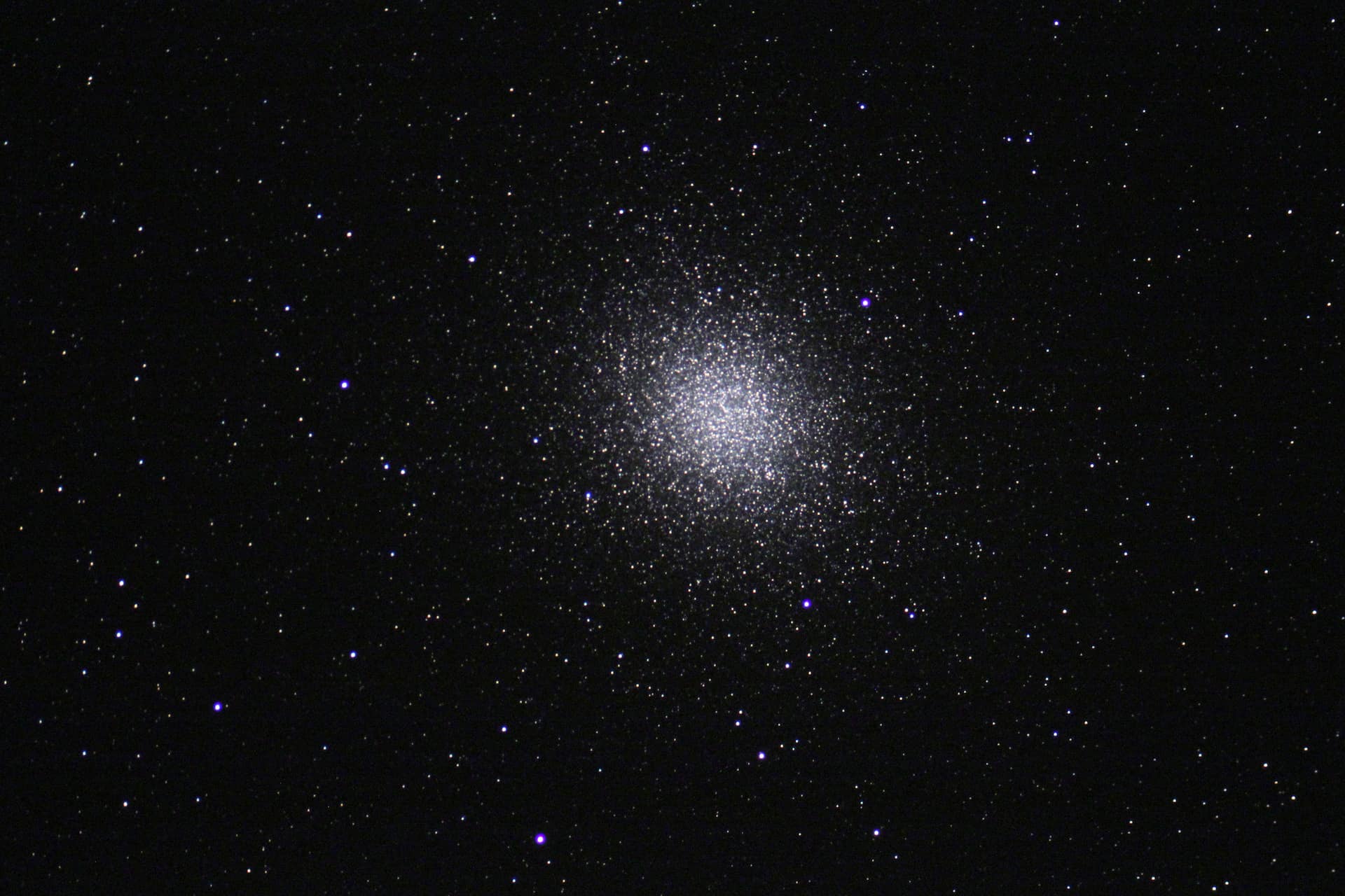 The name "Omega Centauri" should hint that this particular cluster is quite special. As viewed from Earth, Omega Cen (as it is often called) is certainly one of the most dazzling of globular clusters that orbits our galaxy. Before the use of good telescopes (and optics) this cluster was known as a "star" in the constellation of Centaurus (and hence the name). However, under a dark sky this cluster certainly hints at more. It takes on the appearance of fuzzy patch of light- not unlike many other closer star clusters (M41, M44, M35, etc). However, at a distance of 20,000 lights years away, it is only due to the sheer number of stars- easily more than 500,000- that we can see it this easily. A telescopic view reveals the sparkling glitter shown to the left. From Kitt Peak, this cluster barely climbs more than 10 degrees above the horizon. As such, the image quality isn't great, but the overall impression of this cluster is maintained. Interestingly, Omega Cen is one of the few clusters that is currently passing directly through the plane of our galaxy.This image was taken as part of Advanced Observing Program (AOP) program at Kitt Peak Visitor Center during 2014.