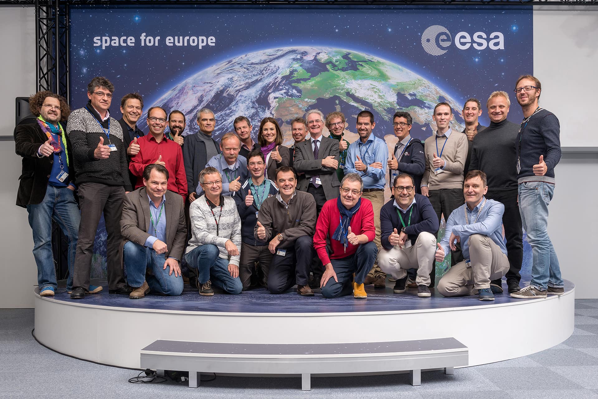 They have a passion for space and are some of the best engineers anywhere, conducting flight operations for exploration, technology and Earth missions worth billions of euros. Above all, ESA’s flight directors and spacecraft operations managers are team leaders, working to motivate people and manage complex systems on the cutting edge of exploration. This photo, taken 2 November, shows 25 of the 40 spacecraft operations managers and flight directors assigned to missions this year. Those not present were away on duty travel, working off site or overseeing live operations or simulation training. At the moment, ESA’s control centre in Darmstadt, Germany, is seeing a historically intense pace of flight operations. There are four training campaigns in progress for Galileo-11/12, LISA Pathfinder, Sentinel-3A and ExoMars to prepare teams for upcoming launches, while flight operations for 15 satellites plus three more controlled from ESA’s Redu Centre in Belgium continue. The launch and operation of any ESA mission requires a multidisciplinary ‘team of teams’ working across the agency and supported by industry and academia. However, it is the spacecraft operations manager, the ubiquitous SOM, who is immediately responsible for day-to-day flight activities, planning and execution, and for solving the myriad problems that inevitably arise when complex satellites voyage into space. An SOM is assigned to each current and upcoming ESA mission, and his/her first task is to build the Flight Control Team, comprising spacecraft engineers and technicians who specialise in each of the mission’s technical areas, including attitude and orbit control, power and thermal and onboard computer systems. The Flight Control Teams are supported by experts working in areas such as flight dynamics, software and ground tracking stations. Teams are multidisciplinary and multicultural, and provide oversight for their missions 24 hours per day, 365 days per year. In the photo Back row, from left: Marcus Kirsch (Xmm Newton), Hervé Côme (Galileo), Kim Nergaard (Meteron), David Evans (OPS-SAT), Bruno Sousa (Cluster), Juan Piñeiro (Aeolus), Richard Southworth (Integral), Isabel Rojo (Seosat), Daniel Mesples (Sentinel-5P), Paolo Ferri (Head of Mission Operations), Franco Marchese (Sentinel-2), Tiago Loureiro (ExoMars/Rover 2018), Ignacio Tanco (Solar Orbiter), Christoph Steiger (GOCE), Paul Steele (Meteron), Peter Schmitz (ExoMars/TGO 2016), Elia Maestroni (Cryosat). Between the rows: Adam Williams (Venus Express), Sylvain Lodiot (Rosetta) Front row: Micha Schmidt (Euclid), Frank Diekmann (Swarm), Andrea Accomazzo (Head of Solar & Planetary Missions, JUICE), Pier P Emanuelli (Head of EO Missions), José Morales (Sentinel-3), David Milligan (Gaia) Absent: Andreas Rudolph (astronomy & fundamental physics division head), Benoit Demelenne (Probas), Danilo Liberatore (Galileo), Elsa Montagnon (BepiColombo), Etienne Tilmans (Probas), Ian Harrison (LISA Pathfinder), Ian Shurmer (Sentinel-1), Liviu Stefanov (Galileo), Michael Schmidt (Head of Studies & Special Projects), Michel Denis (Mars Express), Nic Mardle (EarthCARE, BioMass), Richard Lumb (Galileo), Sandro Matussi (Galileo), Steve Foley (MSG-4), Nigel Head (MSG-4) More information ESA’s operations managers: the ‘Right Stuff’ Ground segment: preparing for launch