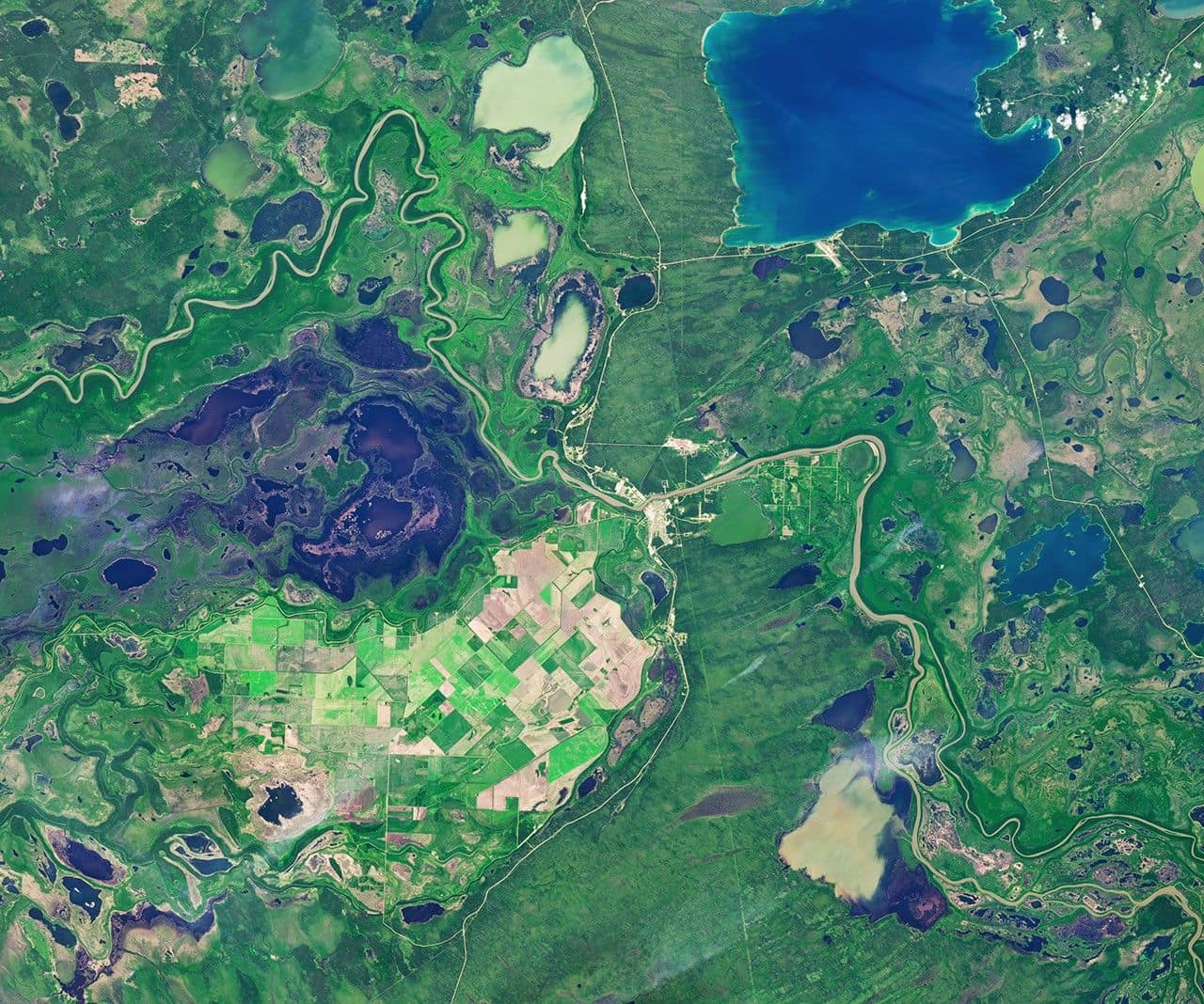 Farmland across the Carrot River Valley, Manitoba’s northernmost agricultural area, moves from summer growth into harvest season in images captured on July 2, 2026 (left), and September 21, 2026 (right), with the OLI (Operational Land Imager) on the NASA-USGS Landsat 9 and Landsat 8 satellites, respectively. NASA Earth Observatory images by Michala Garrison.