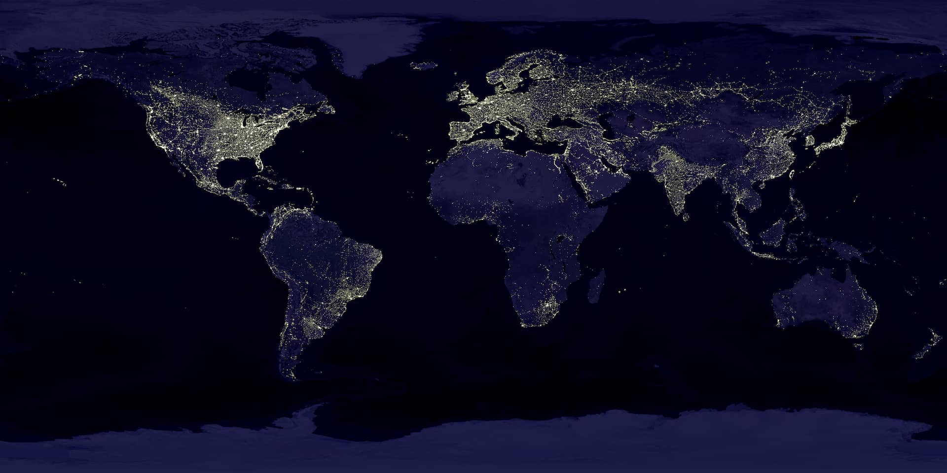 This image of Earth’s city lights was created with data from the Defense Meteorological Satellite Program (DMSP) Operational Linescan System (OLS). Originally designed to view clouds by moonlight, the OLS is also used to map the locations of permanent lights on the Earth’s surface. The brightest areas of the Earth are the most urbanized, but not necessarily the most populated. (Compare western Europe with China and India.) Cities tend to grow along coastlines and transportation networks. Even without the underlying map, the outlines of many continents would still be visible. The United States interstate highway system appears as a lattice connecting the brighter dots of city centers. In Russia, the Trans-Siberian railroad is a thin line stretching from Moscow through the center of Asia to Vladivostok. The Nile River, from the Aswan Dam to the Mediterranean Sea, is another bright thread through an otherwise dark region. Even more than 100 years after the invention of the electric light, some regions remain thinly populated and unlit. Antarctica is entirely dark. The interior jungles of Africa and South America are mostly dark, but lights are beginning to appear there. Deserts in Africa, Arabia, Australia, Mongolia, and the United States are poorly lit as well (except along the coast), along with the boreal forests of Canada and Russia, and the great mountains of the Himalaya.